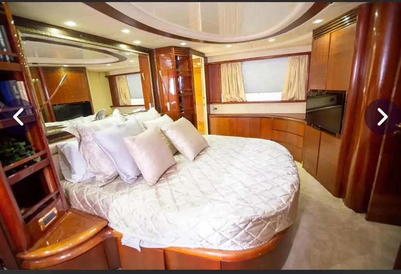  Yacht Photos Pics Luxurious bedroom interior of 2003 Azimut 74 Solar yacht with elegant wood finishes.