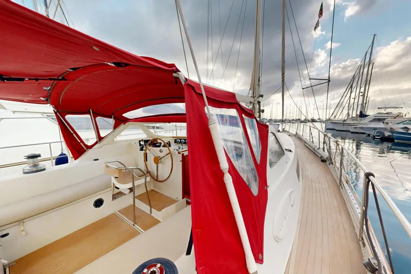  Yacht Photos Pics Sailing yacht Amel Super Maramu 1991 with red canopy, docked in a marina.