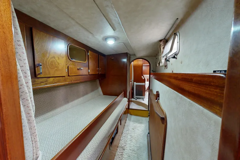  Yacht Photos Pics Interior of 1991 Amel Super Maramu sailboat with cozy wooden cabin and bunk beds.