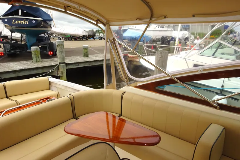 Meandher Yacht Photos Pics 2009 Hunt Yachts Harrier 29 interior with beige seating and wooden table at a marina.