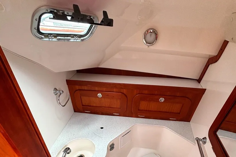 Meandher Yacht Photos Pics 2009 Hunt Yachts Harrier 29 interior with wooden cabinets and a small sink.