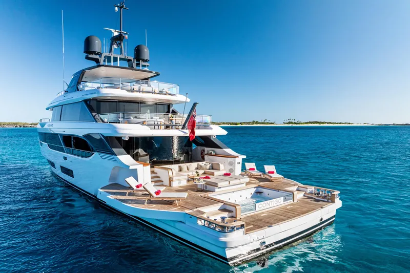 Contigo Yacht Photos Pics Luxurious 2024 Benetti Oasis 40M yacht on serene blue waters, featuring elegant deck design.