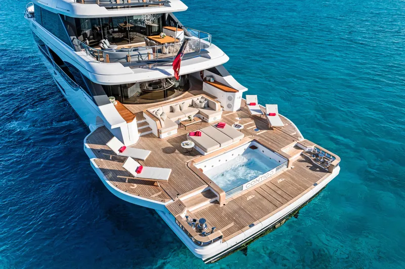 Contigo Yacht Photos Pics Luxurious 2024 Benetti Oasis 40M yacht with spacious deck and jacuzzi on clear blue water.