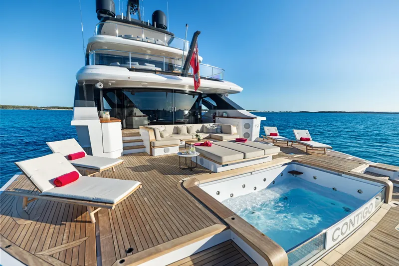 Contigo Yacht Photos Pics Luxurious 2024 Benetti Oasis 40M yacht with jacuzzi and sun loungers on deck.