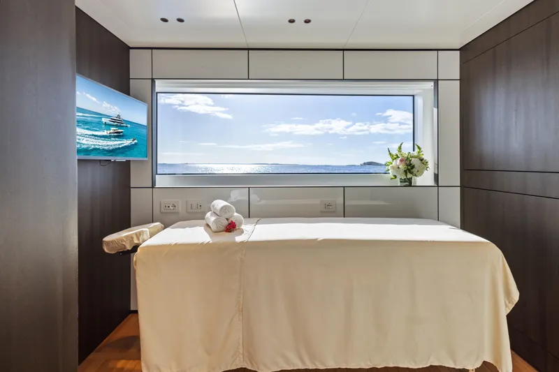 Contigo Yacht Photos Pics Luxurious spa room on 2024 Benetti Oasis 40M yacht with ocean view.