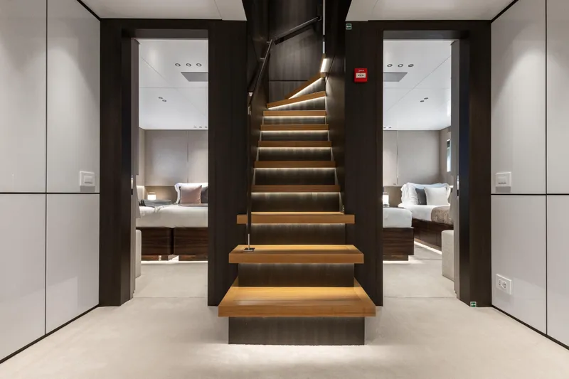Contigo Yacht Photos Pics Luxurious interior of 2024 Benetti Oasis 40M yacht with elegant staircase and modern bedrooms.