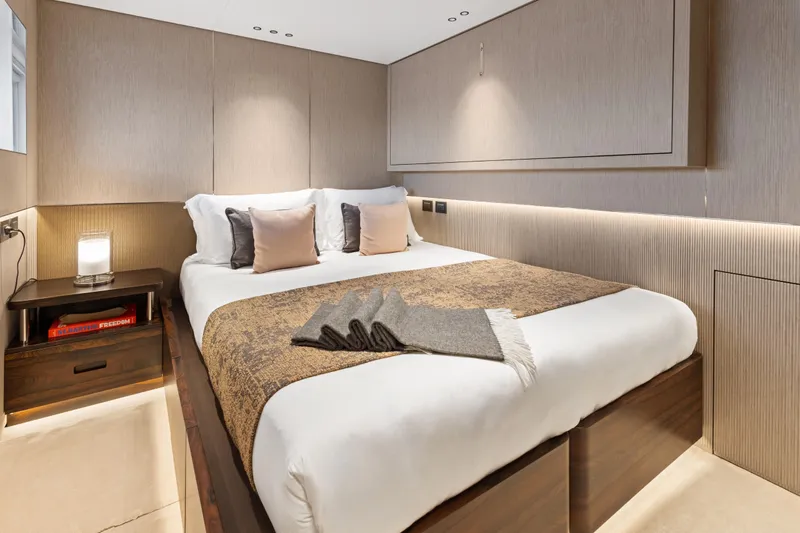 Contigo Yacht Photos Pics Luxurious bedroom interior on 2024 Benetti Oasis 40M yacht, featuring elegant design and cozy ambiance.
