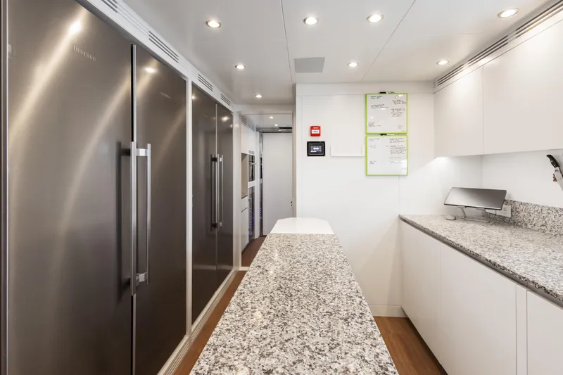 Contigo Yacht Photos Pics Modern kitchen interior on 2024 Benetti Oasis 40M yacht, featuring sleek appliances and granite countertops.