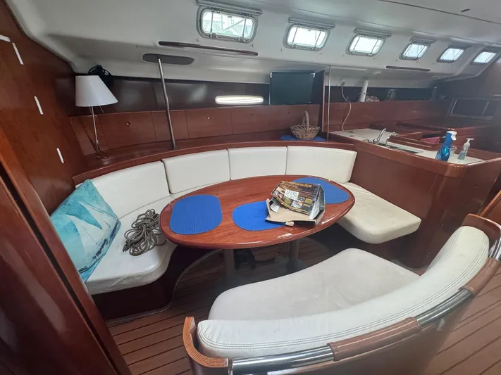 Kaleidoscope Yacht Photos Pics Interior of 2004 Beneteau First 47.7 yacht with cozy seating and dining area.
