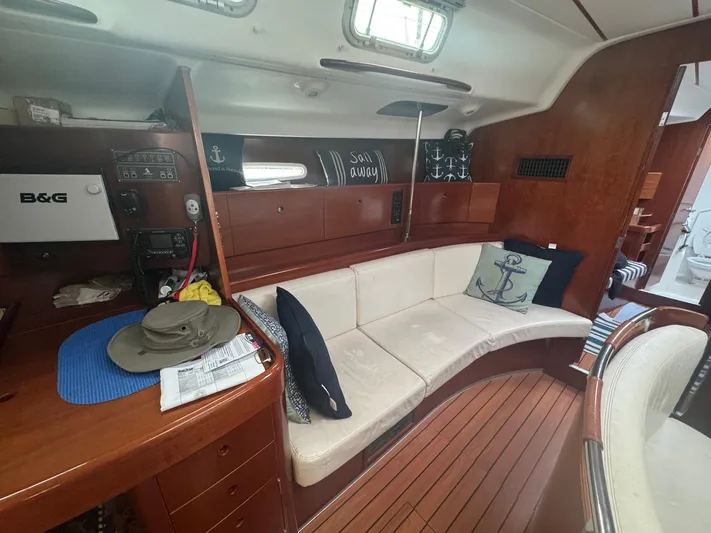 Kaleidoscope Yacht Photos Pics Interior of 2004 Beneteau First 47.7 yacht with cozy seating and nautical decor.