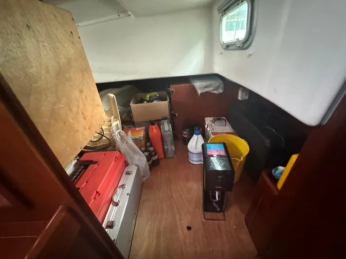 Kaleidoscope Yacht Photos Pics Interior storage area of 2004 Beneteau First 47.7 sailboat with various supplies.