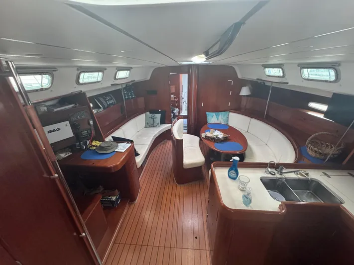 Kaleidoscope Yacht Photos Pics Interior of 2004 Beneteau First 47.7 yacht with wood finish and seating area.