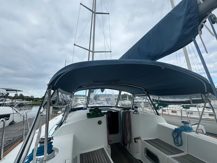 Kaleidoscope Yacht Photos Pics Beneteau First 47.7 sailboat cockpit, 2004 model, docked with blue canopy and rigging.