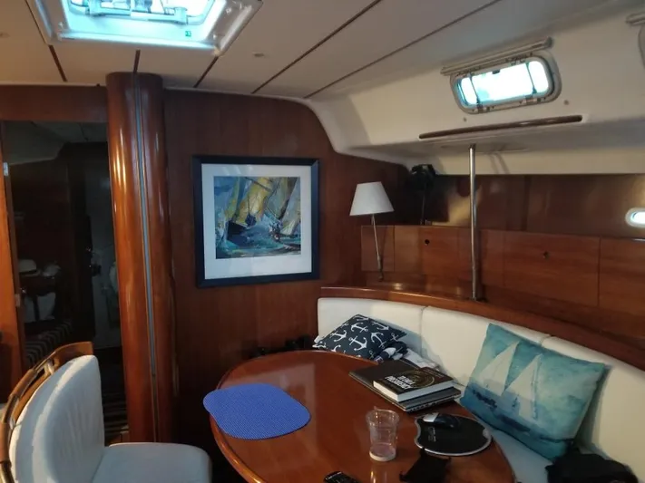 Kaleidoscope Yacht Photos Pics Interior of 2004 Beneteau First 47.7 yacht with cozy seating and nautical decor.