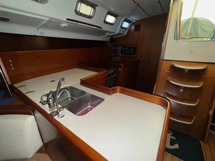 Kaleidoscope Yacht Photos Pics Interior of 2004 Beneteau First 47.7 yacht, featuring a modern kitchen galley.