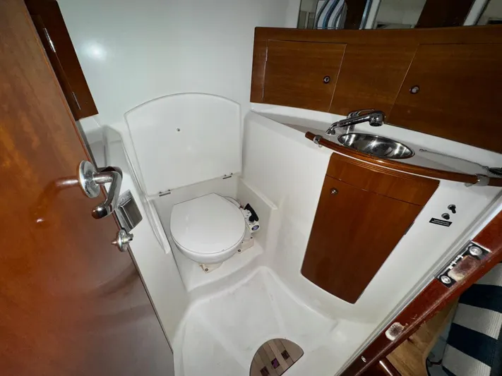 Kaleidoscope Yacht Photos Pics 2004 Beneteau First 47.7 yacht bathroom with wooden cabinetry and compact design.
