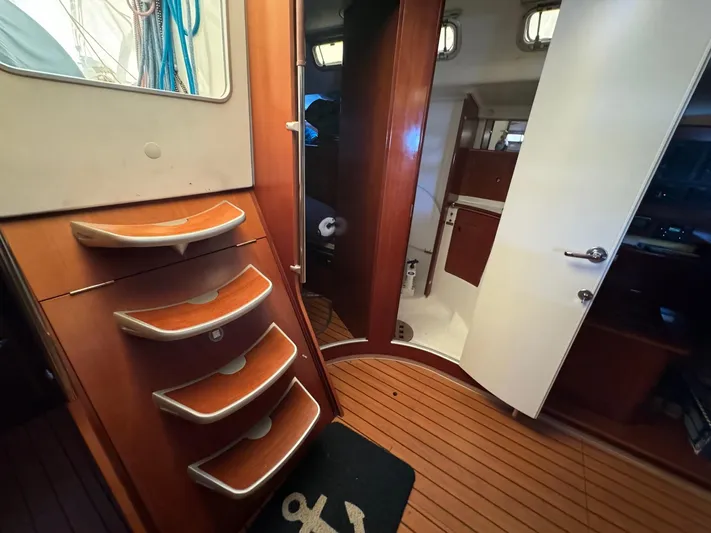 Kaleidoscope Yacht Photos Pics Interior of 2004 Beneteau First 47.7 yacht with wooden flooring and steps.