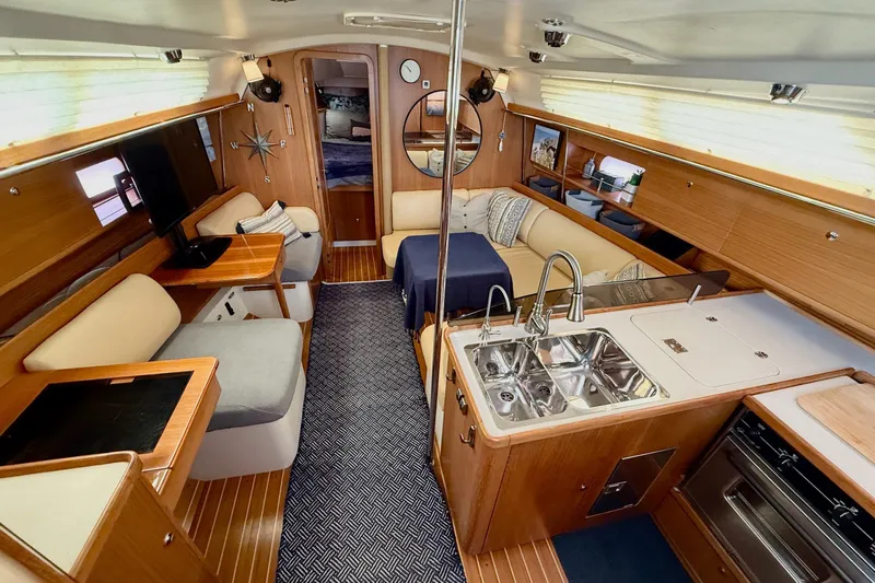 Magic Yacht Photos Pics Luxurious interior of a 2011 Catalina 355 yacht with modern kitchen and cozy seating area.