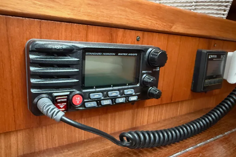 Magic Yacht Photos Pics Standard Horizon radio on 2011 Catalina 355 sailboat, featuring distress button and GPS functionality.