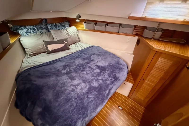 Magic Yacht Photos Pics Cozy cabin interior of 2011 Catalina 355 sailboat with plush bedding and wooden accents.