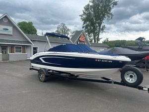 2017 Chaparral 21 H2O Sport boat on trailer, parked outside dealership.
