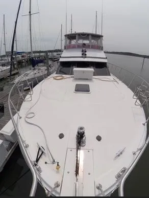 Intoxication Yacht Photos Pics 1995 Jefferson 48 Rivanna yacht docked at marina, showcasing spacious deck and sleek design.