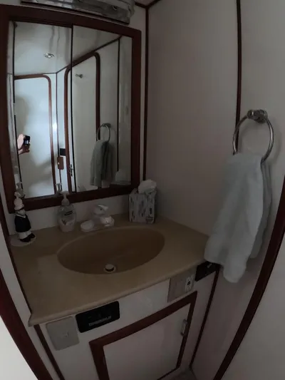 Intoxication Yacht Photos Pics Bathroom interior of a 1995 Jefferson 48 Rivanna yacht with sink and mirror.