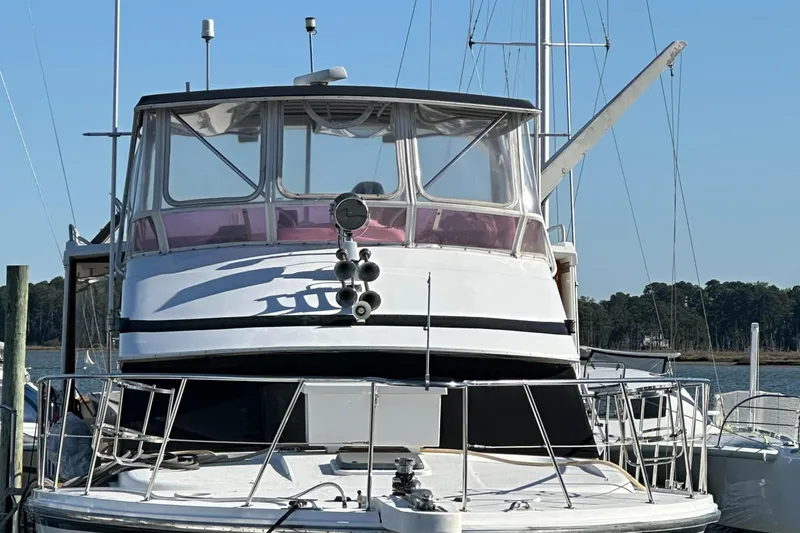 Intoxication Yacht Photos Pics 1995 Jefferson 48 Rivanna yacht docked, front view with clear sky background.