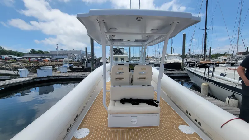  Yacht Photos Pics 2022 Sea Blade 36 R boat docked at a marina, featuring a spacious deck and seating.