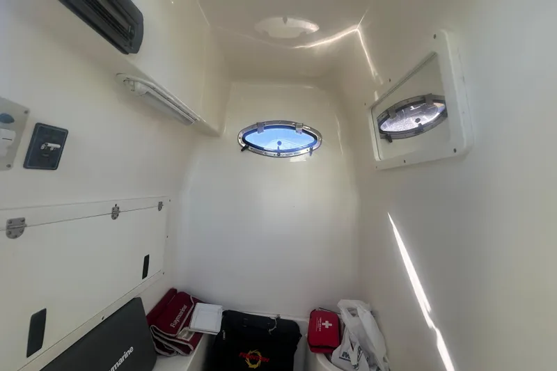 4play Yacht Photos Pics Interior cabin of 2013 Fountain 38 Sportfish CC Open Bow with portholes and storage.