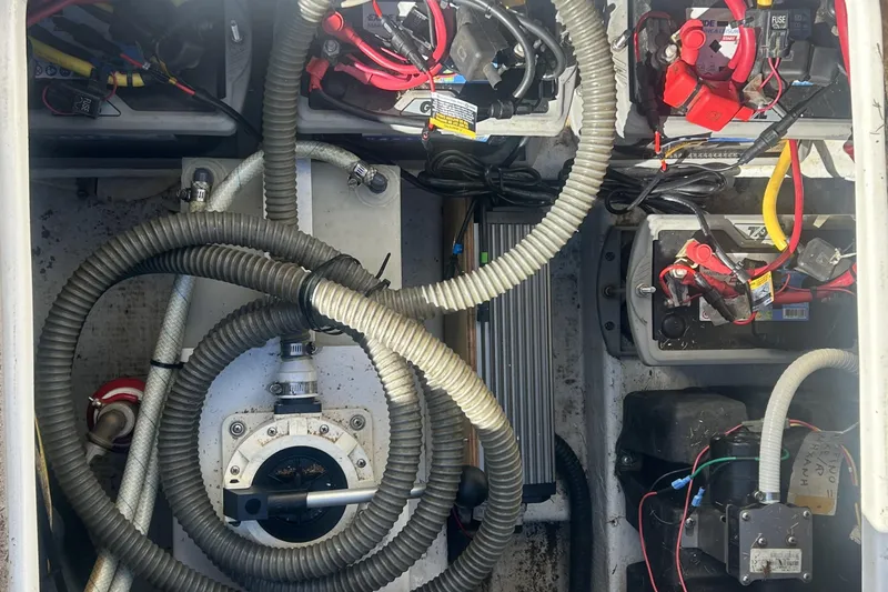 4play Yacht Photos Pics Engine compartment of a 2013 Fountain 38 Sportfish CC Open Bow boat, showing batteries and wiring.