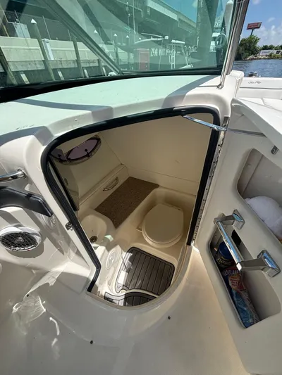  Yacht Photos Pics 2014 Sea Ray 300 SLX boat interior with compact restroom and storage.