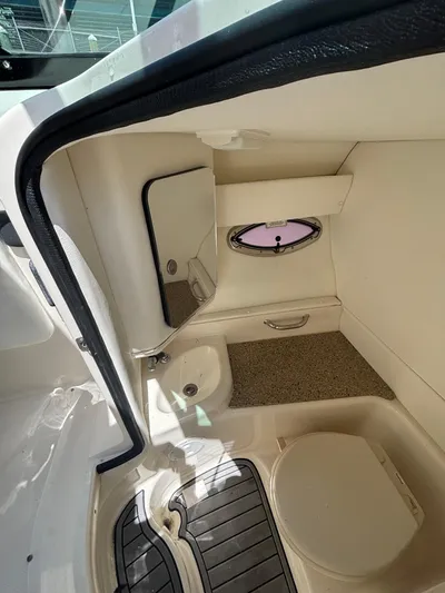  Yacht Photos Pics Interior cabin of 2014 Sea Ray 300 SLX boat with porthole and seating area.