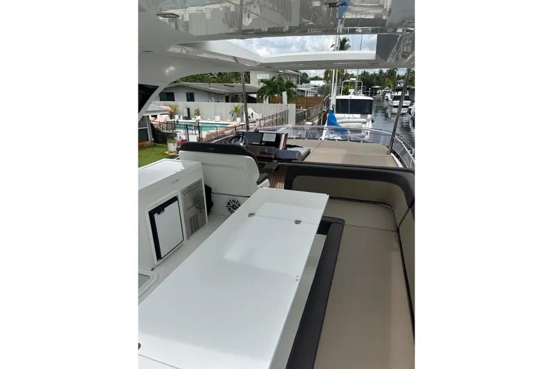 Bugsy Yacht Photos Pics 2020 Galeon 550 Fly yacht interior with seating and navigation area.
