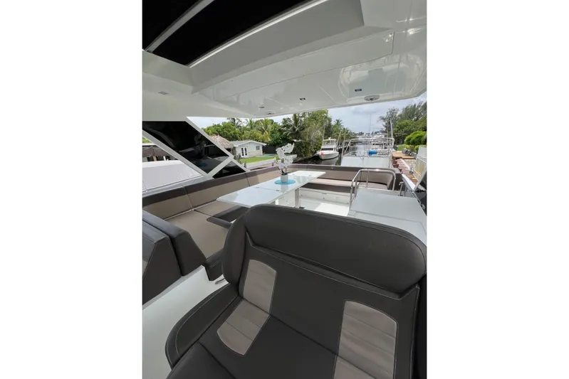 Bugsy Yacht Photos Pics Luxurious interior of 2020 Galeon 550 Fly yacht with elegant seating and table.