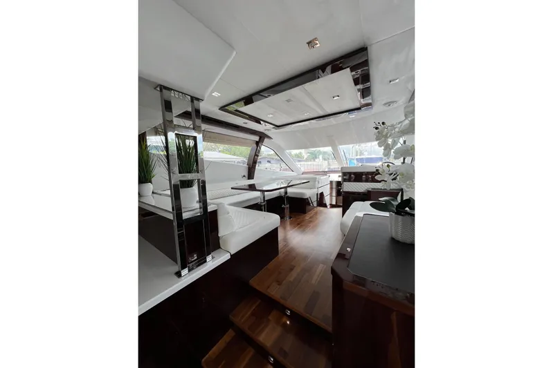Bugsy Yacht Photos Pics Luxurious interior of 2020 Galeon 550 Fly yacht with modern decor and wooden flooring.