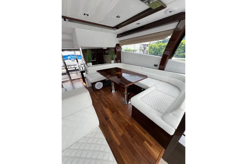 Bugsy Yacht Photos Pics Luxurious interior of 2020 Galeon 550 Fly yacht with elegant seating and wooden flooring.