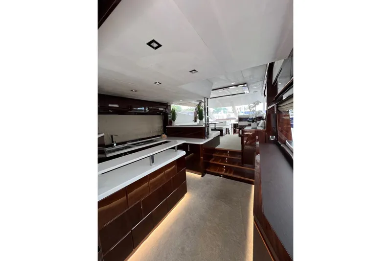 Bugsy Yacht Photos Pics Luxurious interior of 2020 Galeon 550 Fly yacht with modern kitchen and seating area.