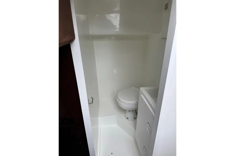 Bugsy Yacht Photos Pics Compact bathroom in 2020 Galeon 550 Fly yacht, featuring a toilet and storage.