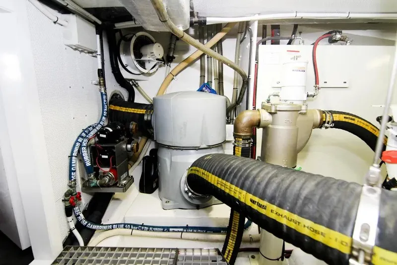 Bugsy Yacht Photos Pics Engine room of 2020 Galeon 550 Fly yacht with visible hoses and machinery.