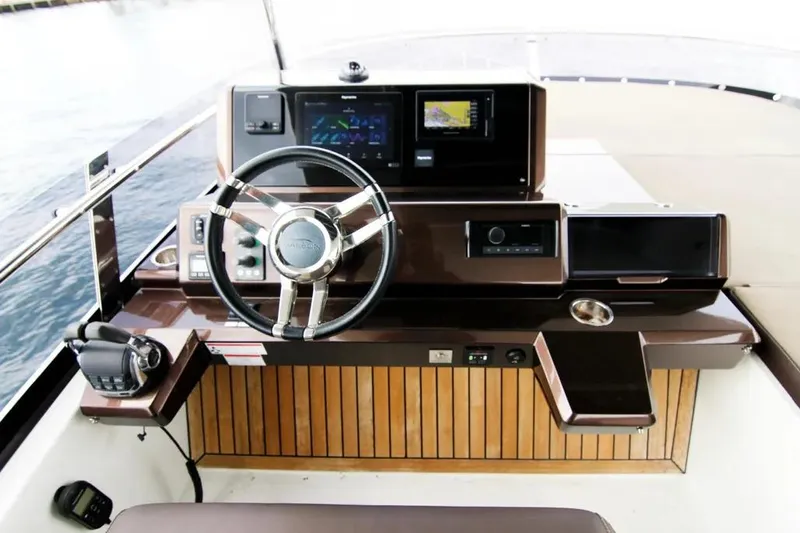 Bugsy Yacht Photos Pics Helm of 2020 Galeon 550 Fly yacht with modern navigation equipment and steering wheel.