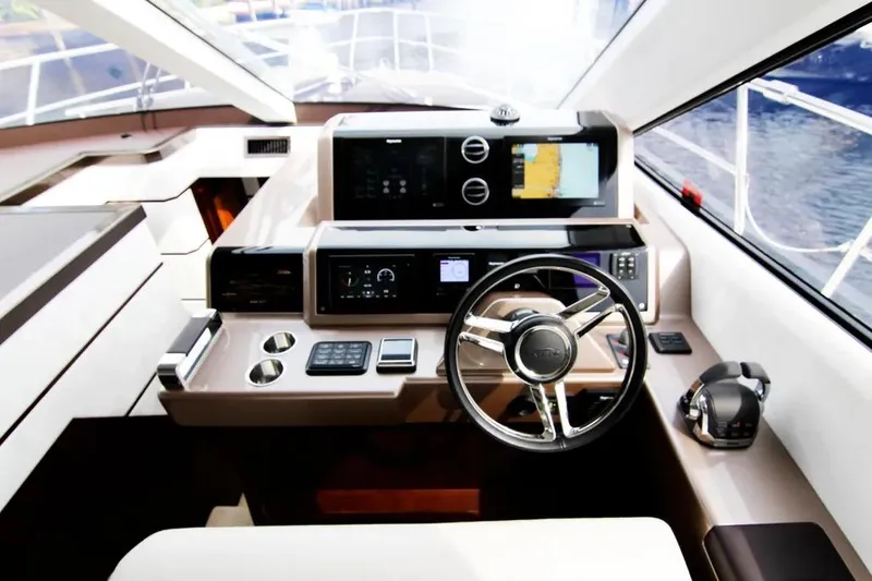 Bugsy Yacht Photos Pics Cockpit of 2020 Galeon 550 Fly yacht with modern navigation equipment and steering wheel.