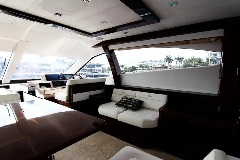 Bugsy Yacht Photos Pics Luxurious interior of 2020 Galeon 550 Fly yacht with elegant seating and panoramic windows.
