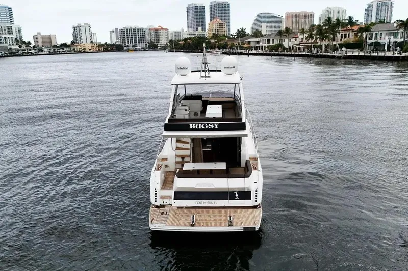 Bugsy Yacht Photos Pics 2020 Galeon 550 Fly yacht on water, city skyline in background.