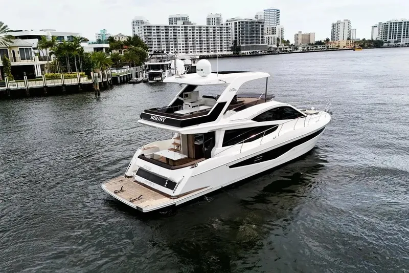 Bugsy Yacht Photos Pics Luxury 2020 Galeon 550 Fly yacht cruising near urban waterfront.