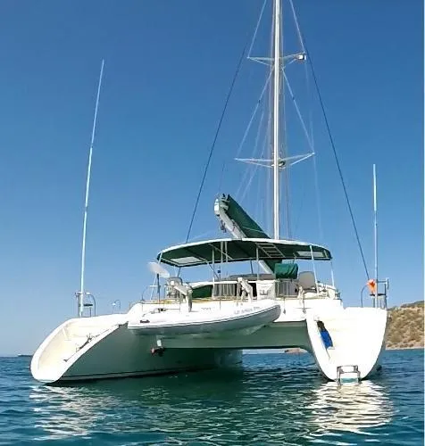  Yacht Photos Pics 1997 Fountaine Pajot Marquises 56 catamaran sailing on clear blue water.