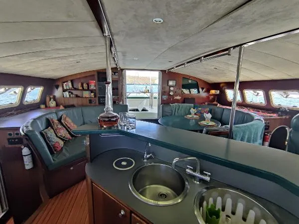  Yacht Photos Pics Luxurious interior of 1997 Fountaine Pajot Marquises 56 catamaran with spacious seating and modern amenities.