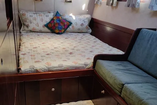  Yacht Photos Pics Cozy cabin interior of 1997 Fountaine Pajot Marquises 56 with bed and seating area.