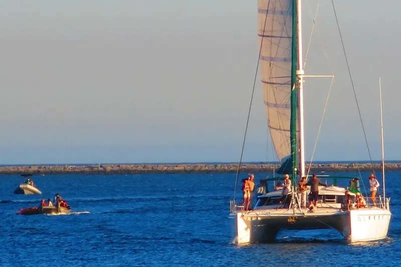  Yacht Photos Pics Sailing catamaran Fountaine Pajot Marquises 56, 1997, with people onboard in open water.