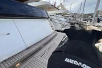 2023 Astondoa AS8 yacht docked at marina with Seadoo cover in foreground.